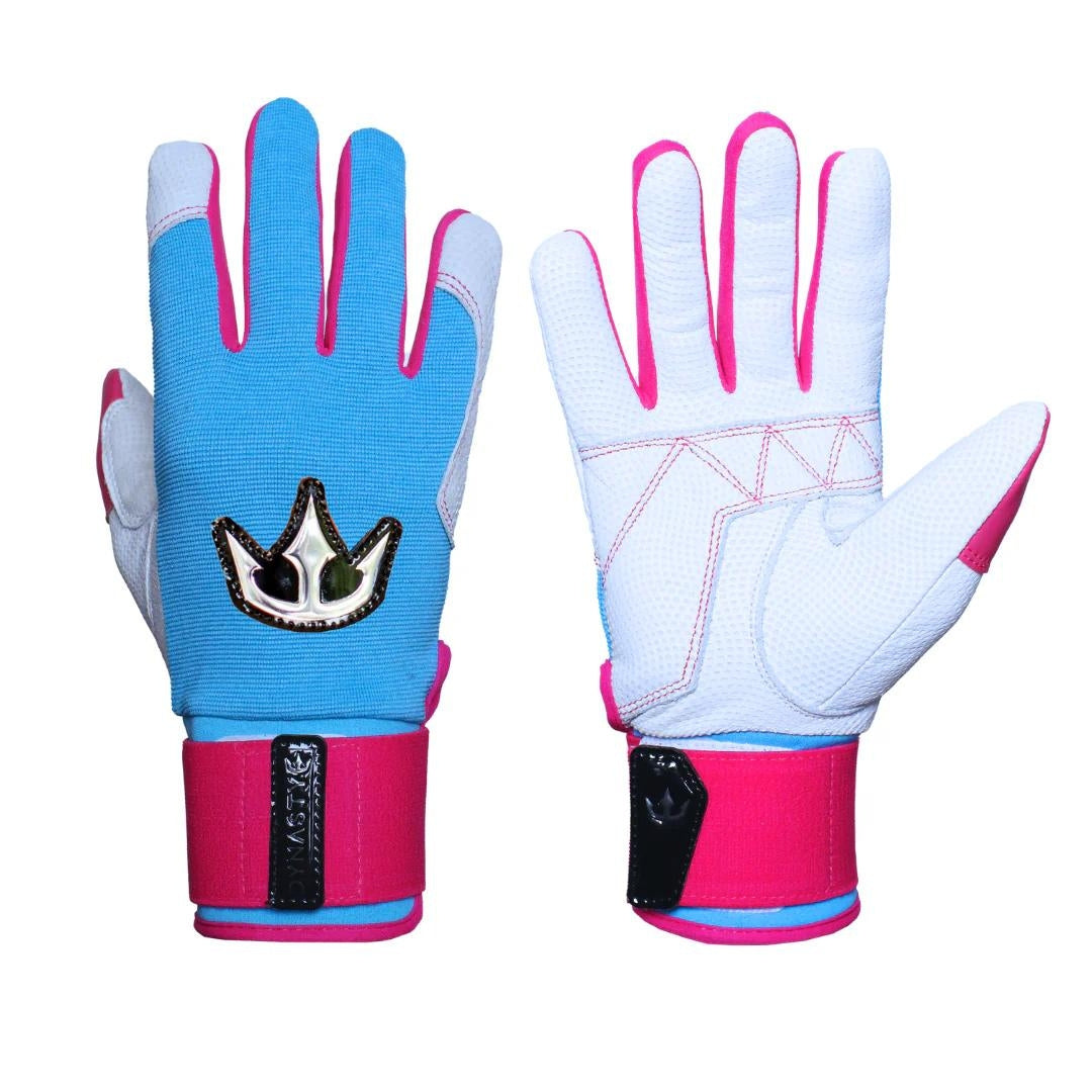  A pair of batting gloves. The left glove shows a blue back with a white crown emblem, while the right glove reveals a white palm with pink accents. Pink wrist straps feature black patches with the Dynasty Baseball logo.