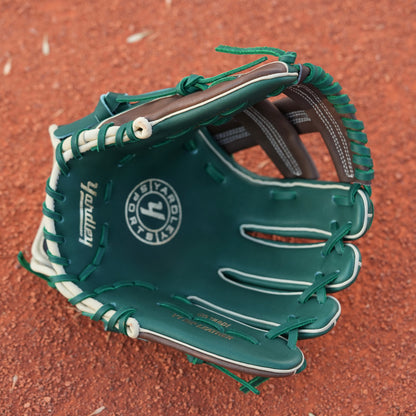 A baseball glove on a dirt field. The glove is primarily green with brown and beige accents, featuring intricate stitching and a patch with text on the wrist area. The letter Y is stitched on the side, indicating Yardley Sports.