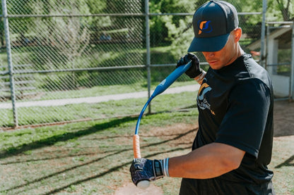 A batter wearing Perfect Swings USA apparel getting ready to take a swing with the Perfect Swings USA Tempo Trainer